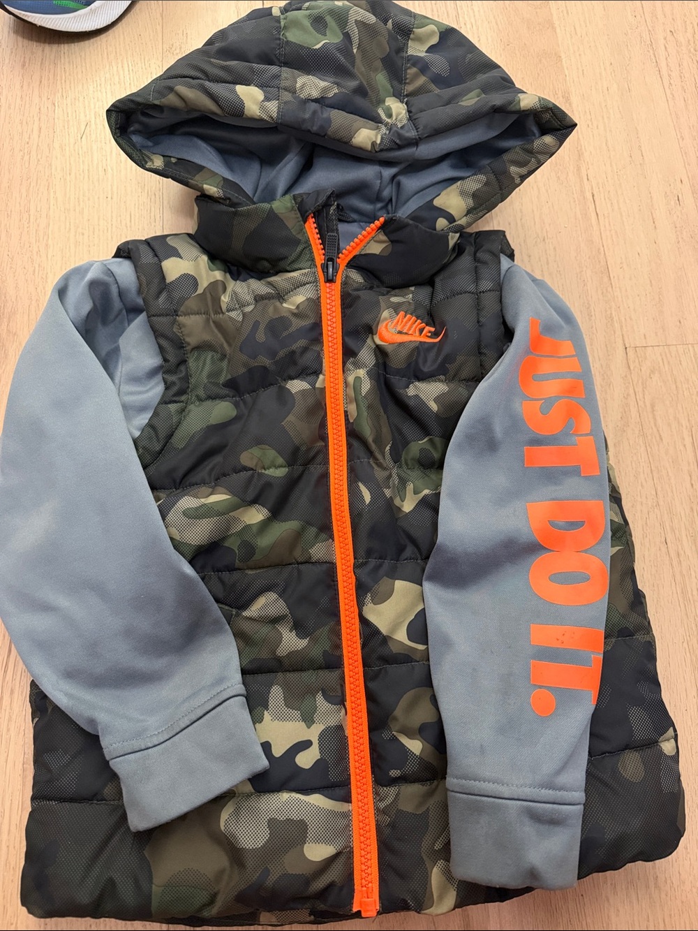 Nike Kids Camouflage Puffer Jacket with Gray Sleeves and Orange Accents